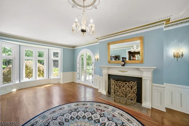 a dining room with furniture a chandelier and wooden floor