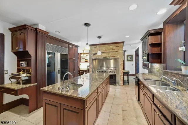 a living room with furniture a chandelier and a flat screen tv