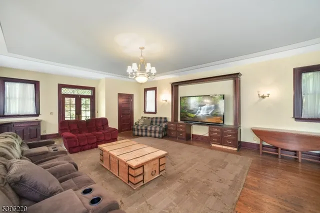a living room with furniture and a chandelier