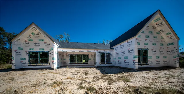 a view of a house with wooden fence