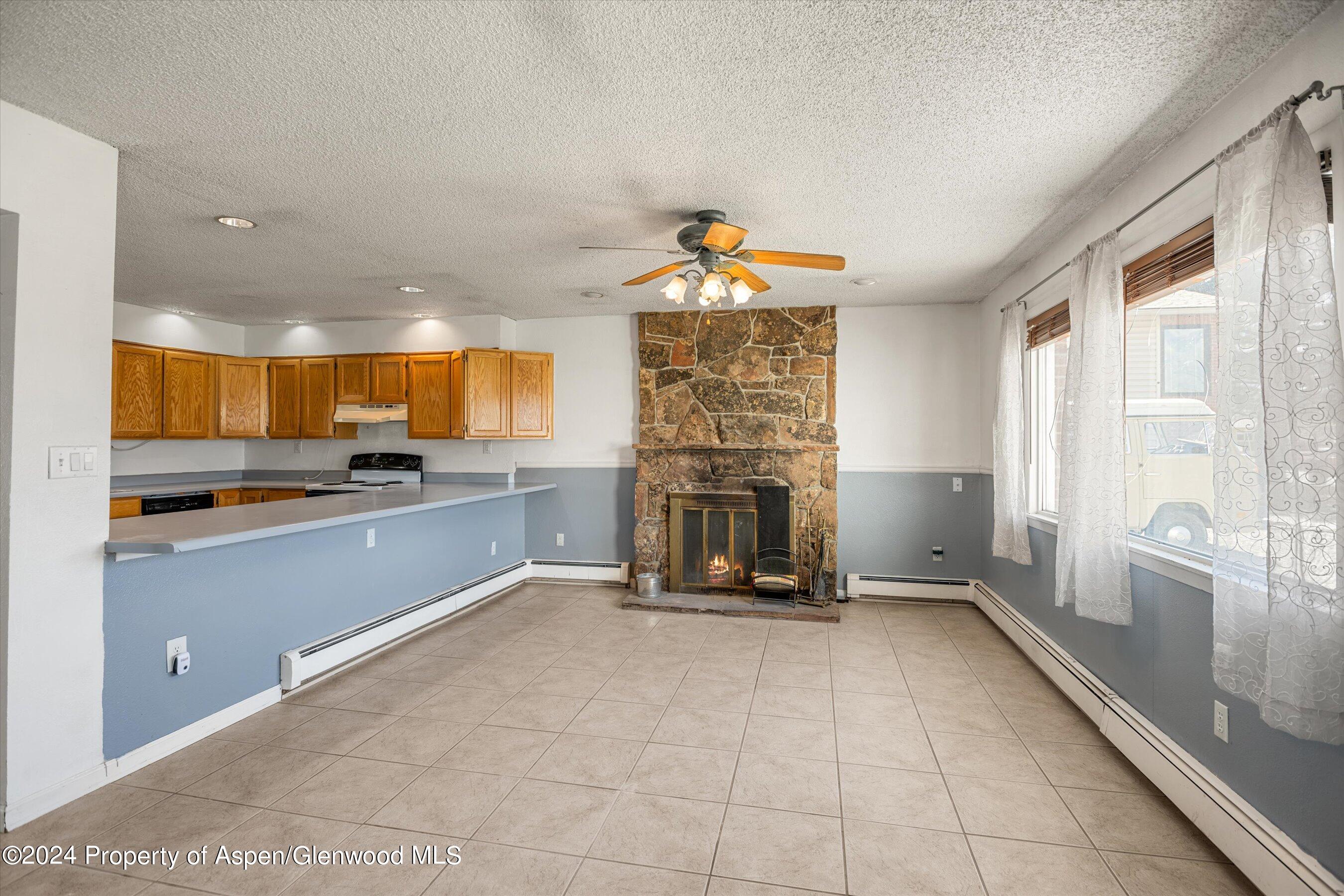 346 Will Avenue Rifle, CO 81650 - Photo 9 of 26 a open kitchen with granite countertop a stove and a sink