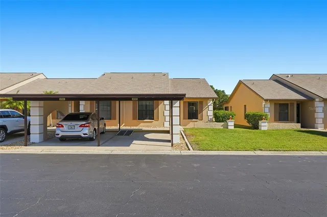 a car parked in front of a house with a yard