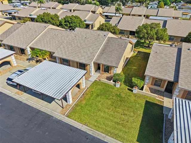 an aerial view of a house with a yard