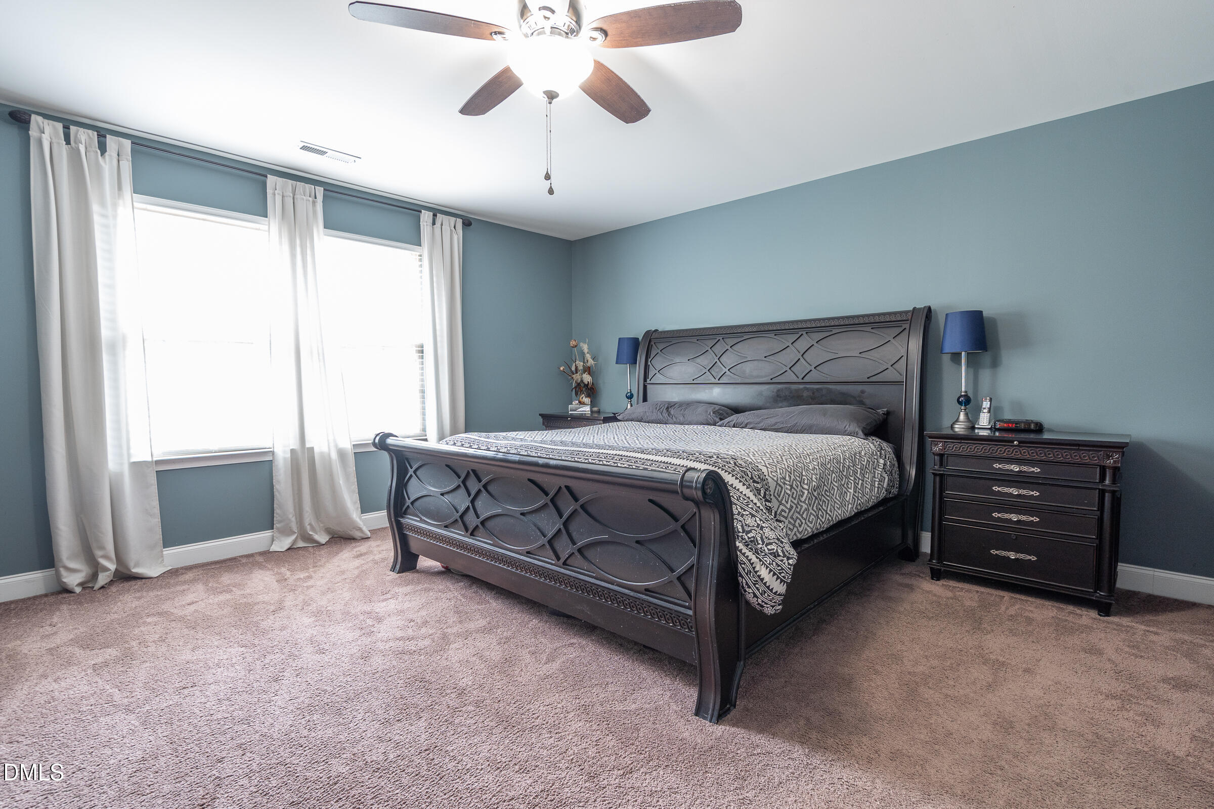 2756 Shepherd Valley Street Raleigh, NC 27610 - Photo 13 of 30 a bedroom with a bed and a chandelier