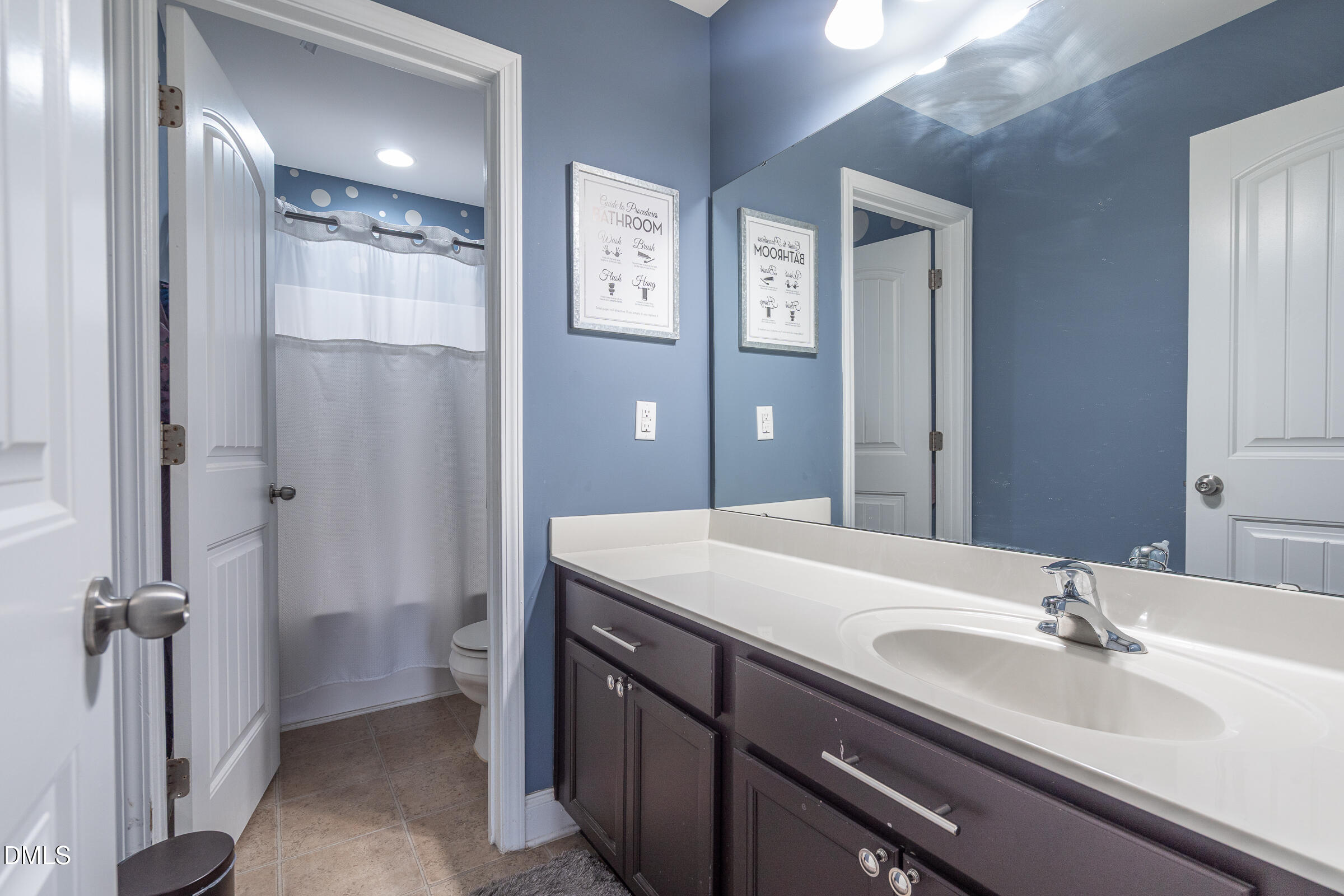2756 Shepherd Valley Street Raleigh, NC 27610 - Photo 15 of 30 a bathroom with a sink double vanity and a mirror