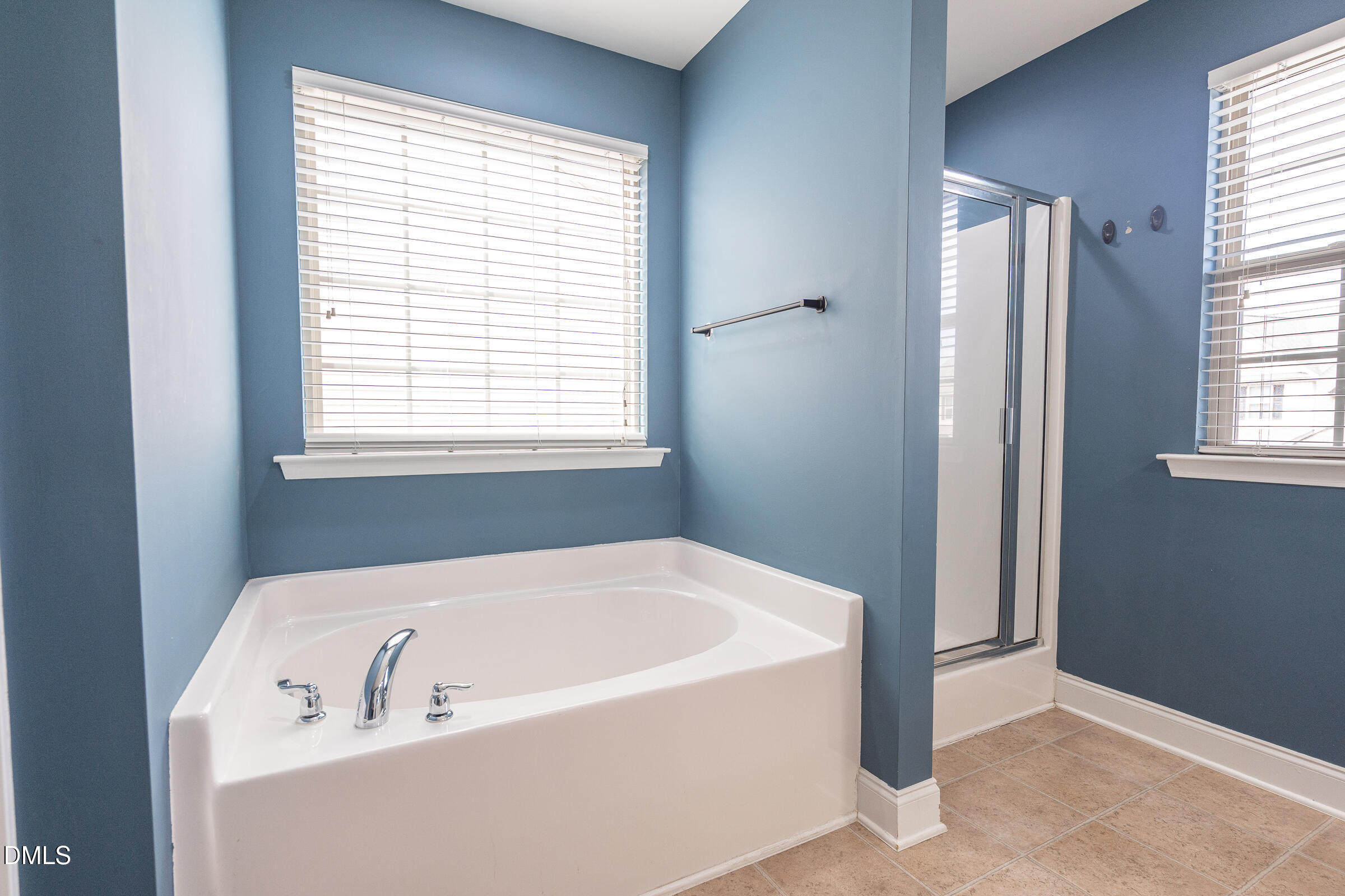 2756 Shepherd Valley Street Raleigh, NC 27610 - Photo 18 of 30 a white bath tub sitting in a bathroom next to a window