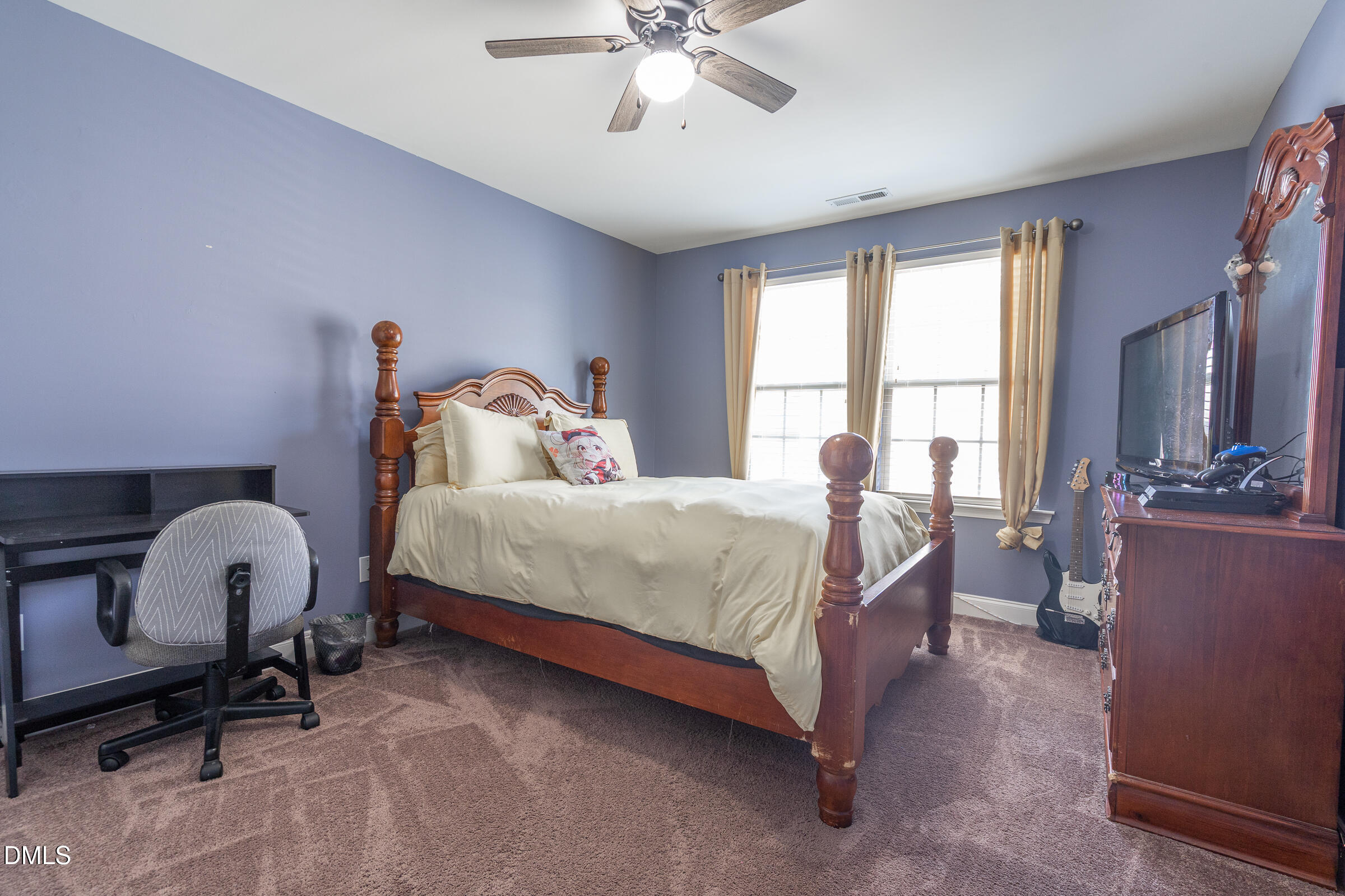 2756 Shepherd Valley Street Raleigh, NC 27610 - Photo 20 of 30 a bedroom with a bed and a chandelier