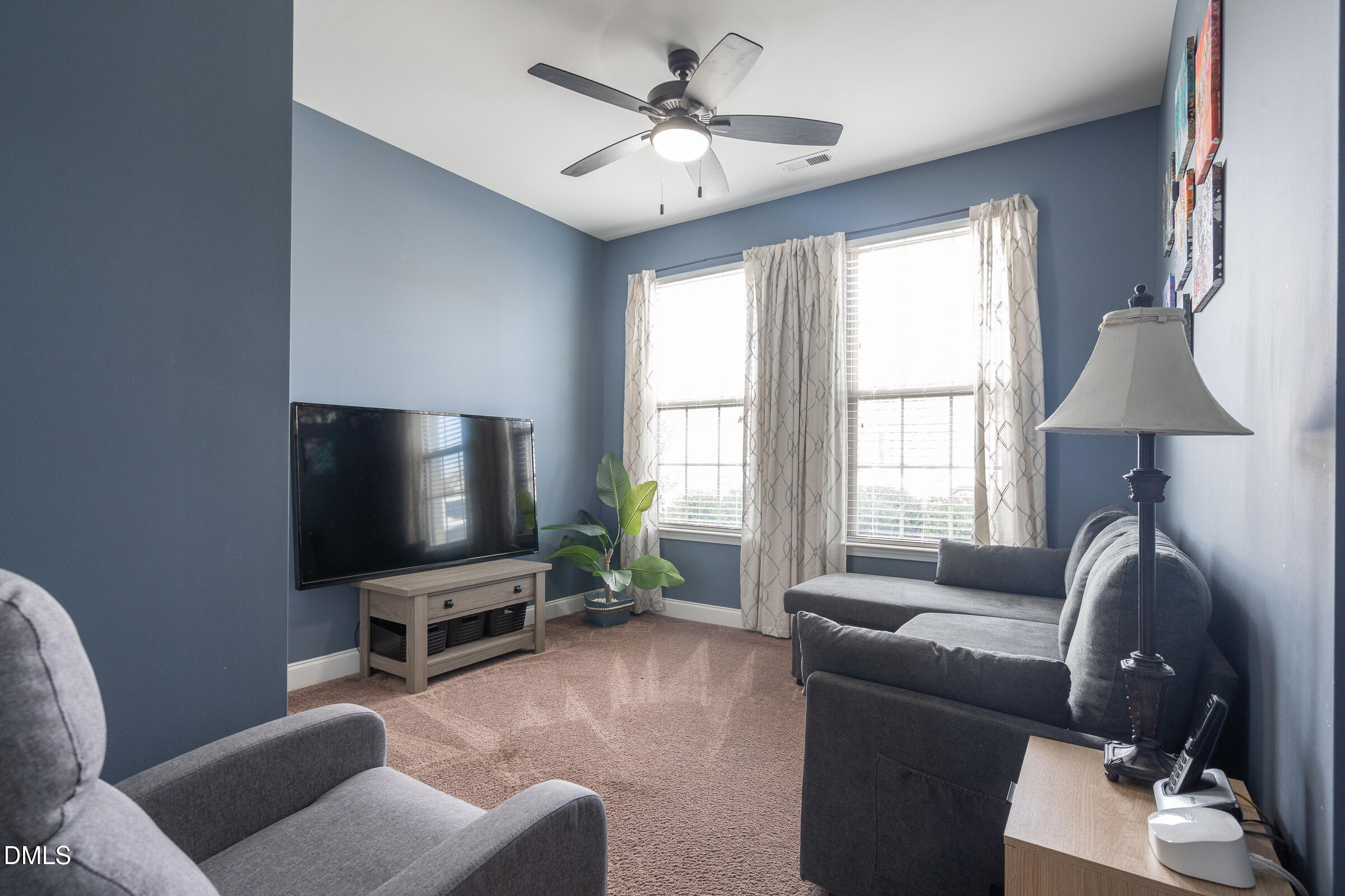 2756 Shepherd Valley Street Raleigh, NC 27610 - Photo 3 of 30 a living room with furniture and a flat screen tv