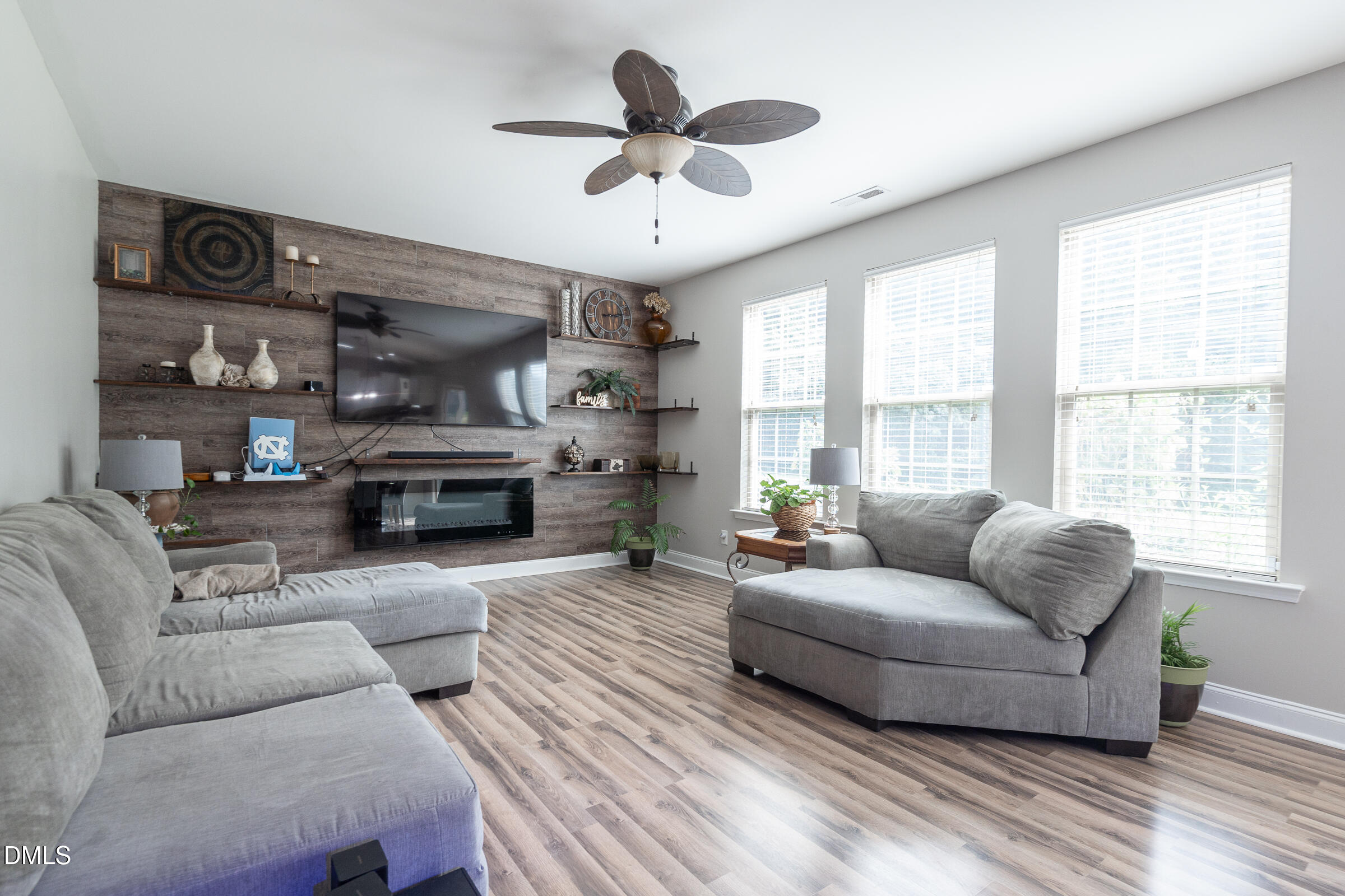 2756 Shepherd Valley Street Raleigh, NC 27610 - Photo 8 of 30 a living room with furniture a fireplace and a large window