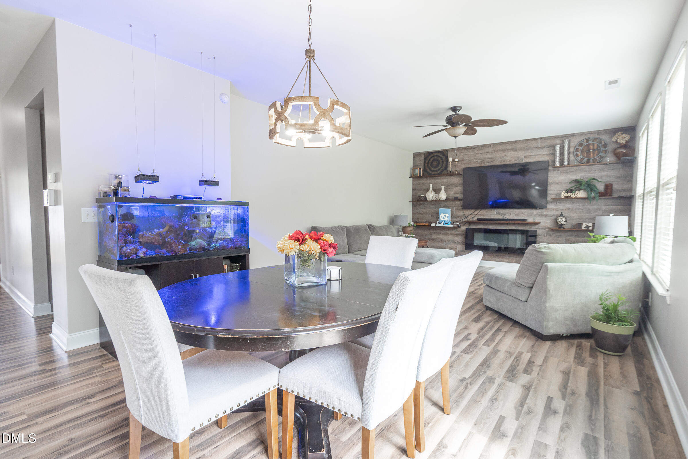 2756 Shepherd Valley Street Raleigh, NC 27610 - Photo 10 of 30 a view of a dining room with furniture a chandelier and wooden floor