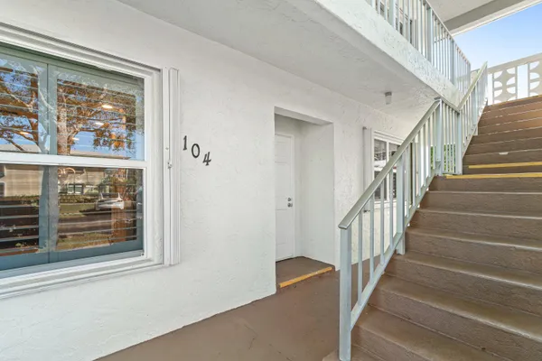 a view of a hallway with wooden floor and entryway