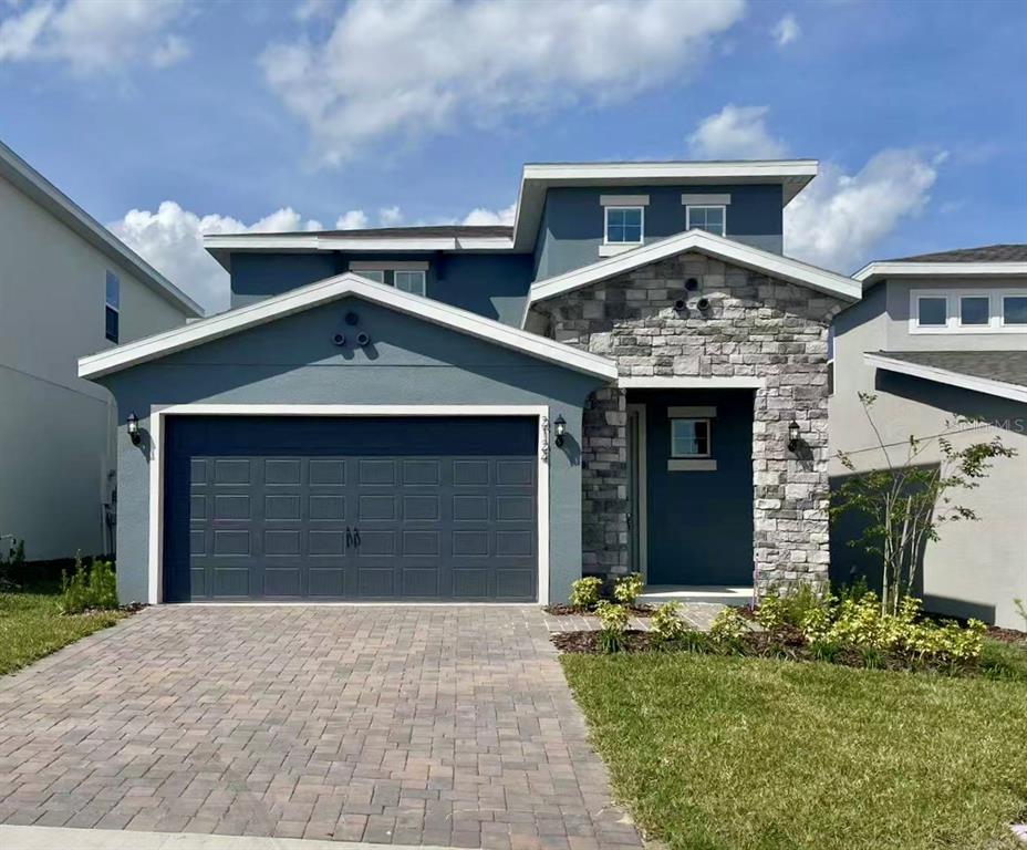 2124 Sunshine Peak Drive Clermont, FL 34715 - Photo 1 of 1 a front view of a house with a yard and garage