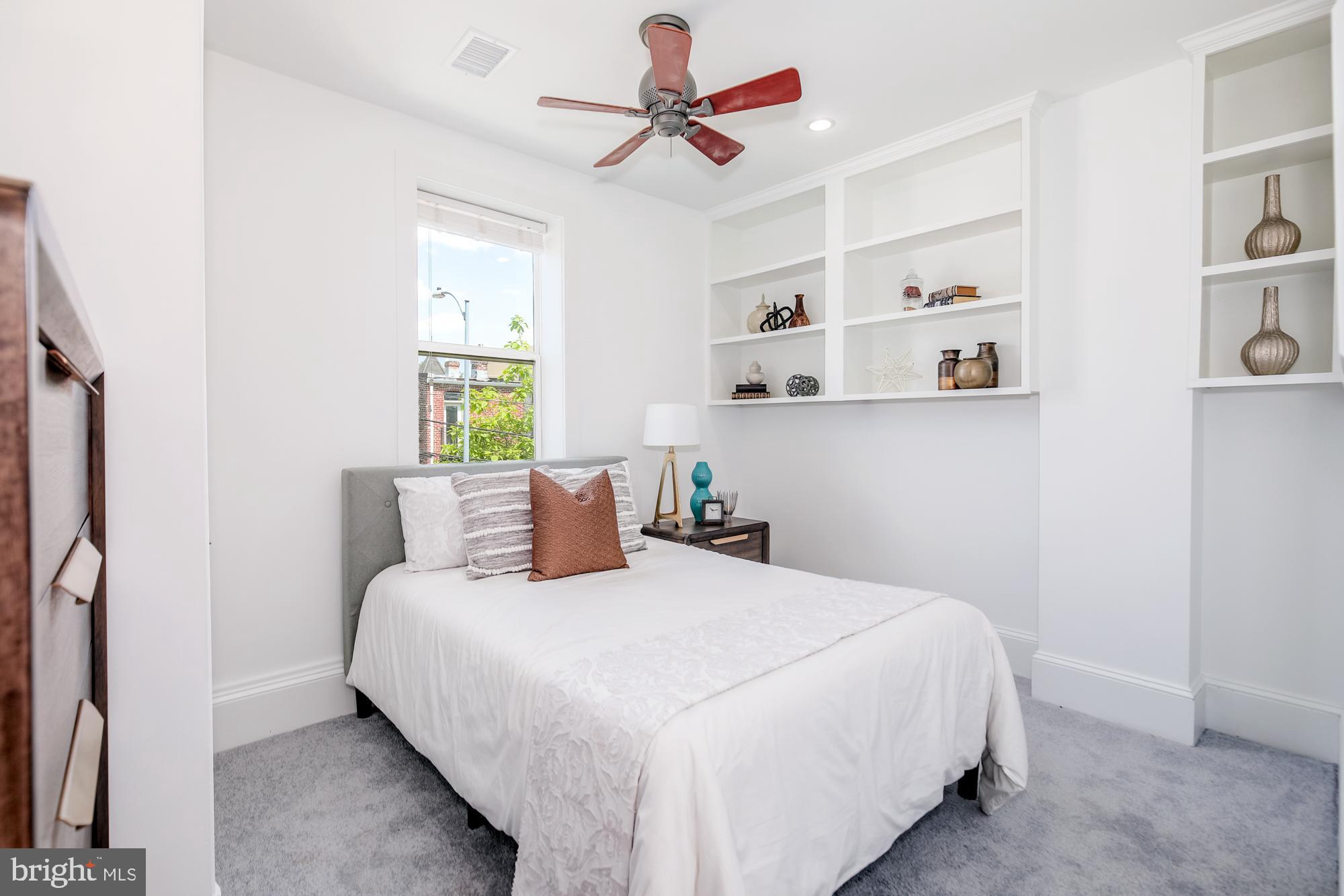 151 Thomas Street Northwest Washington, DC 20001 - Photo 18 of 40 a bedroom with a bed and a chandelier