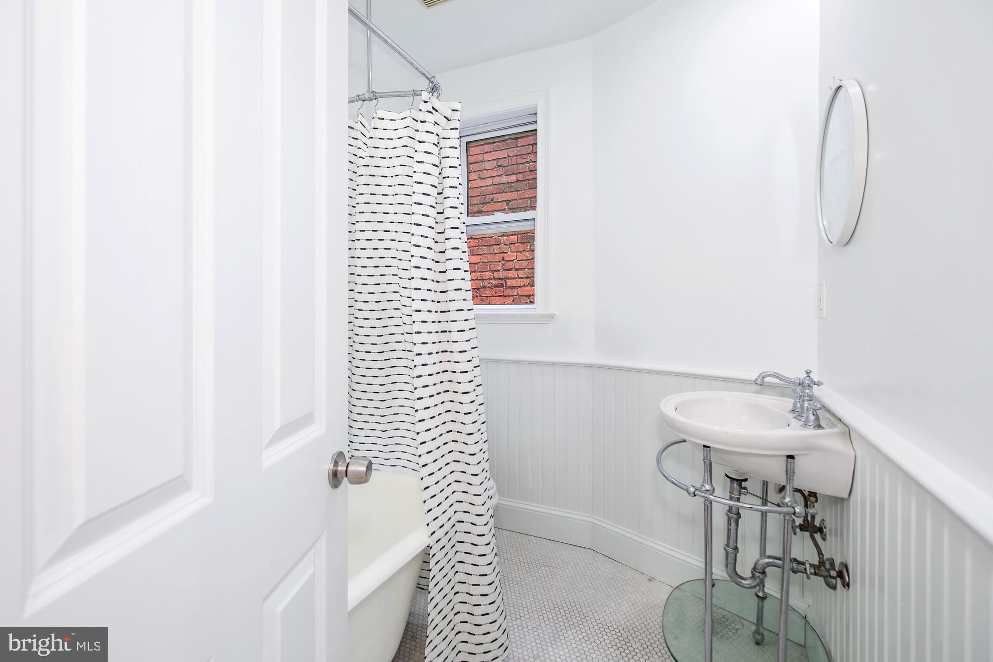 151 Thomas Street Northwest Washington, DC 20001 - Photo 20 of 40 a bathroom with a sink and a mirror