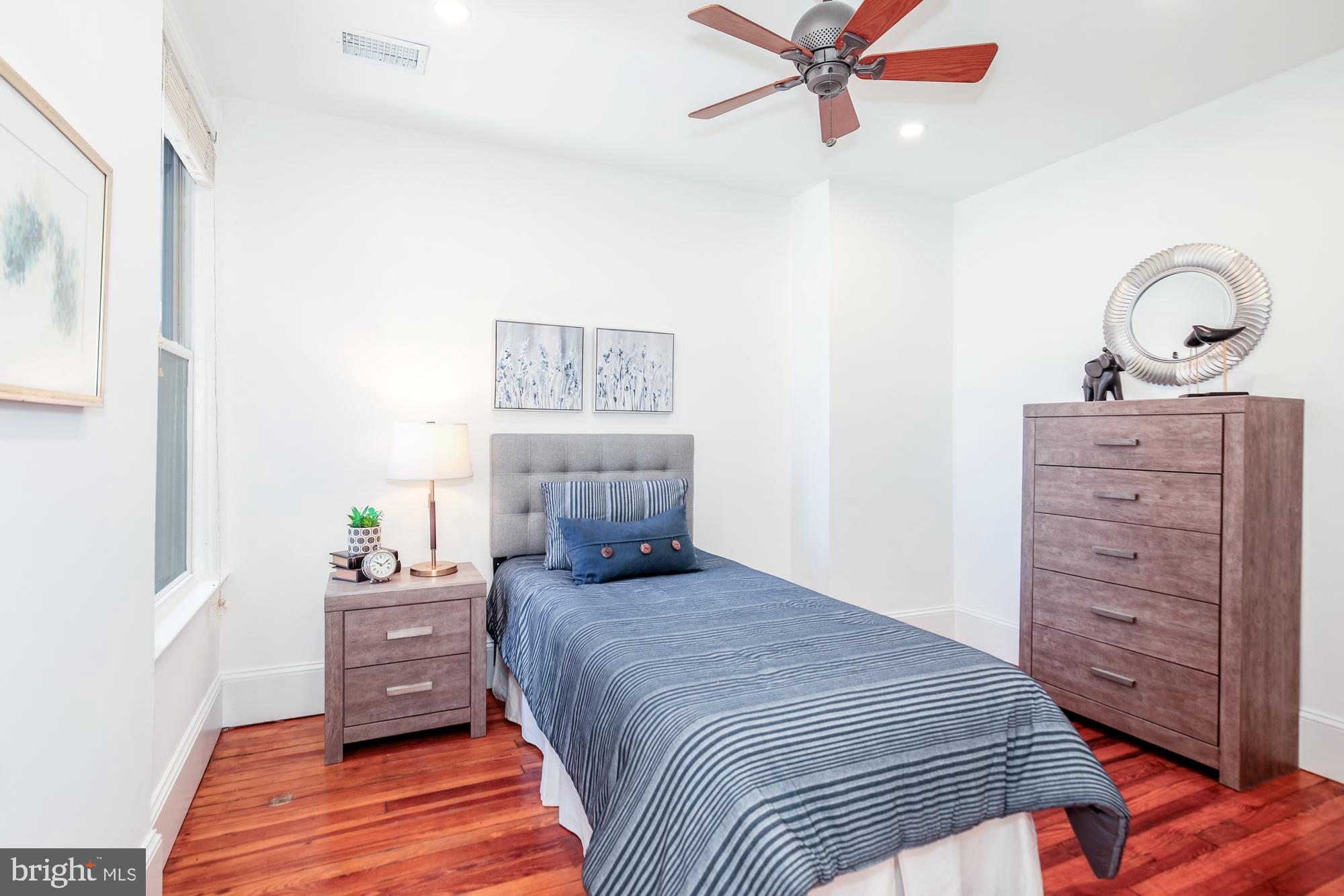 151 Thomas Street Northwest Washington, DC 20001 - Photo 21 of 40 a bedroom with a bed and a dresser