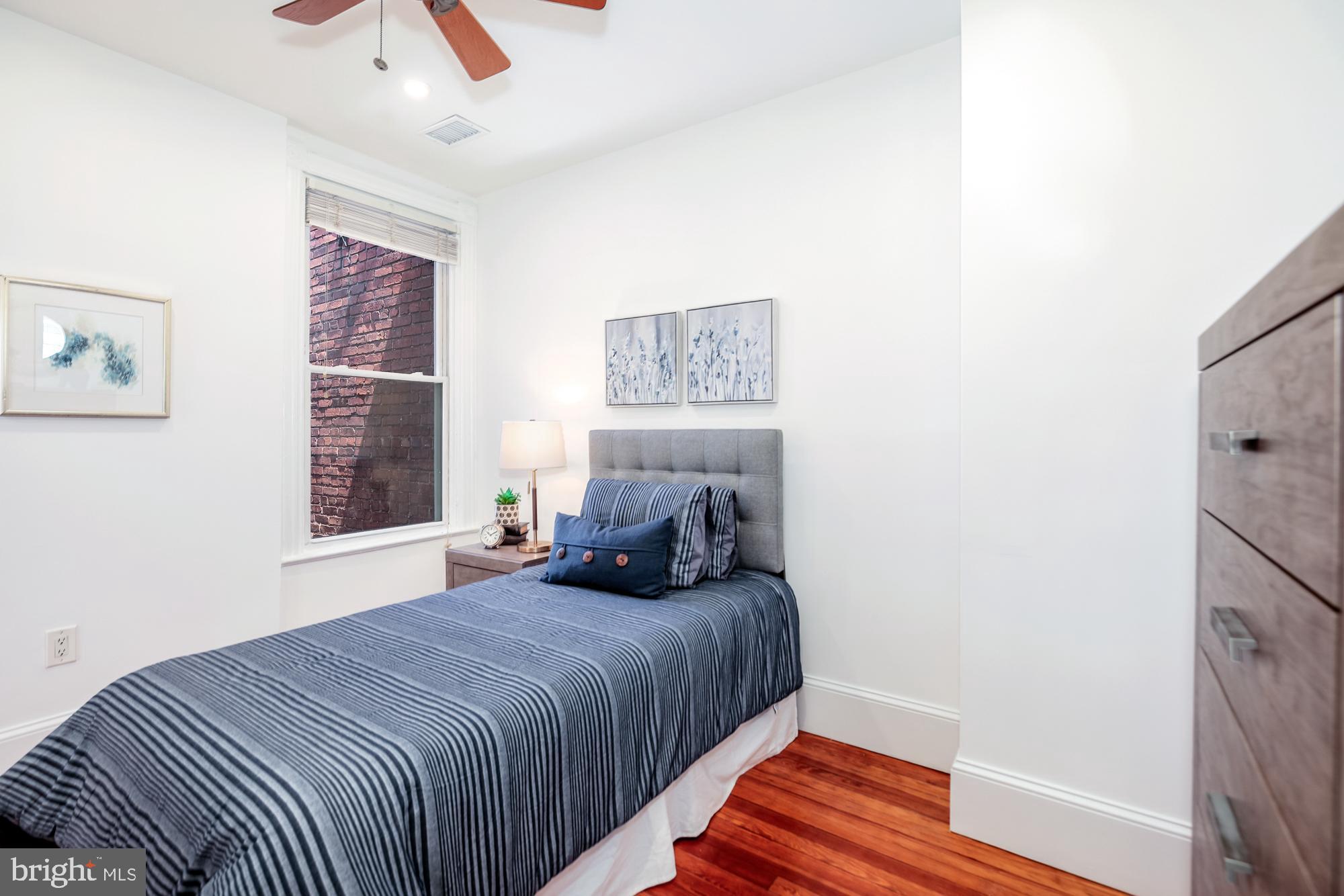 151 Thomas Street Northwest Washington, DC 20001 - Photo 22 of 40 a bedroom with a bed and a window