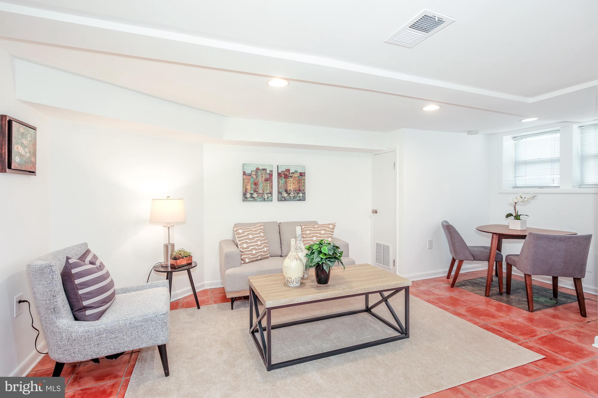151 Thomas Street Northwest Washington, DC 20001 - Photo 26 of 40 a living room with furniture a rug and a dining table