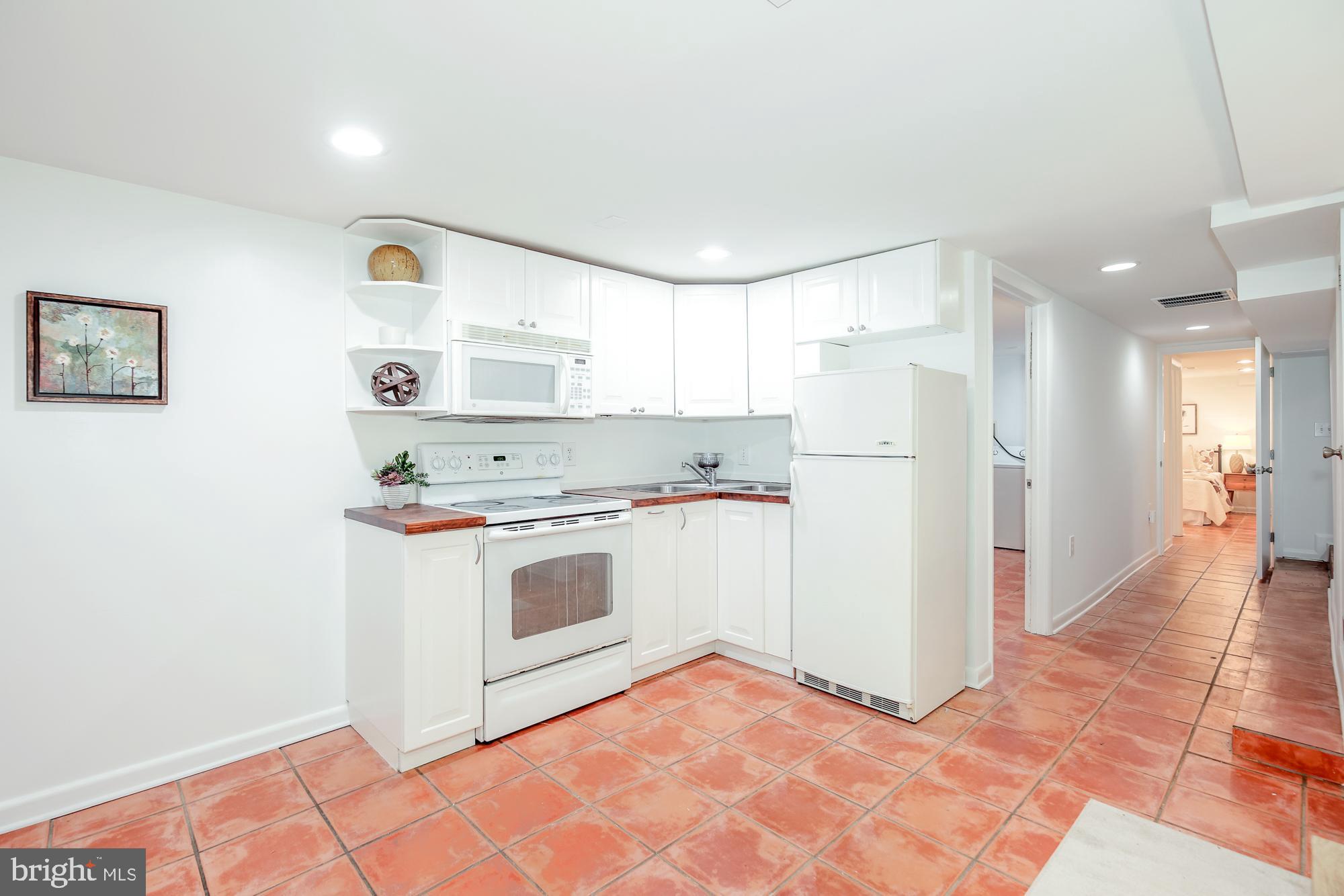 151 Thomas Street Northwest Washington, DC 20001 - Photo 27 of 40 a kitchen with stainless steel appliances granite countertop a refrigerator and a stove top oven