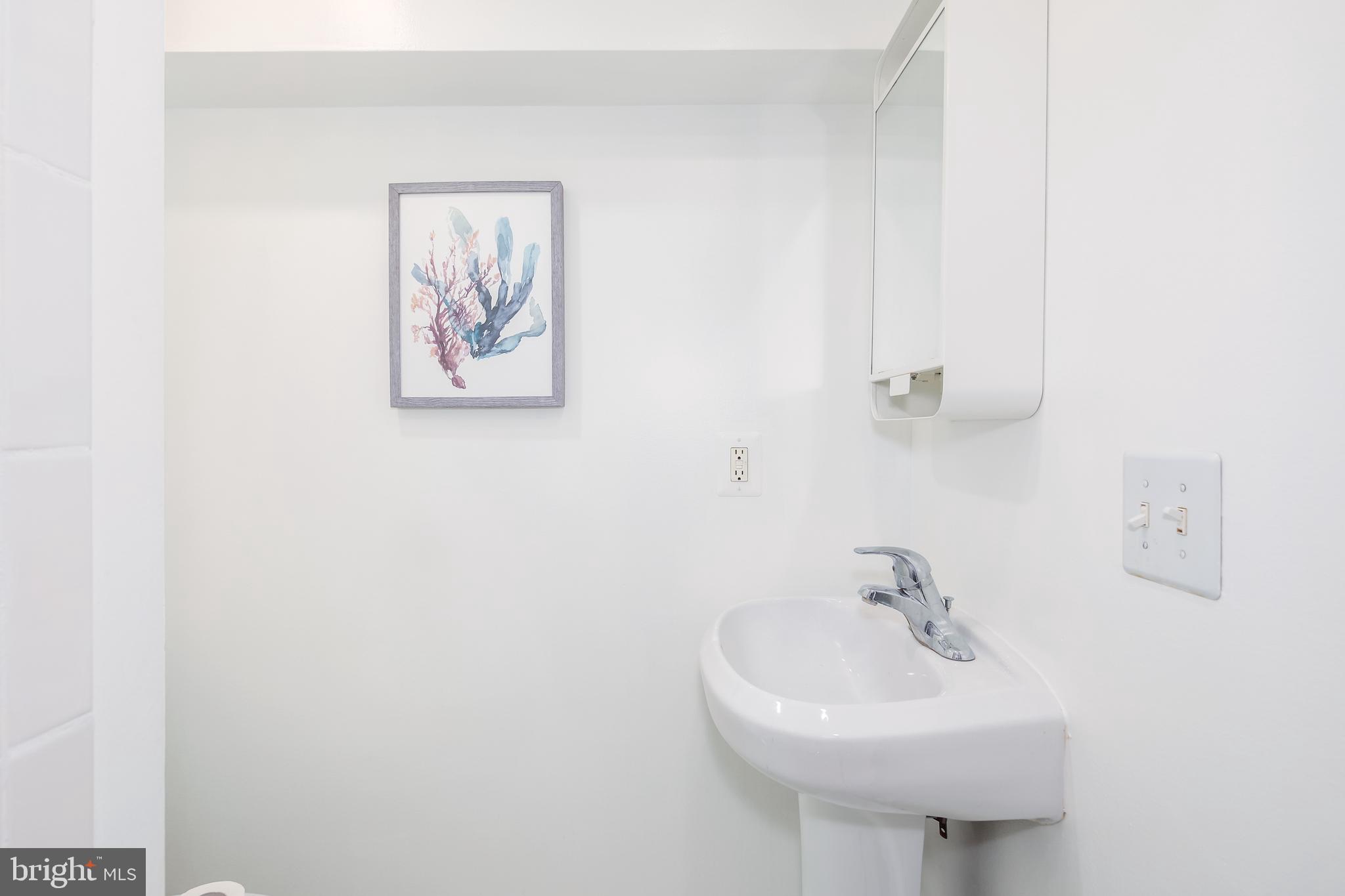 151 Thomas Street Northwest Washington, DC 20001 - Photo 31 of 40 a bathroom with a sink and a mirror