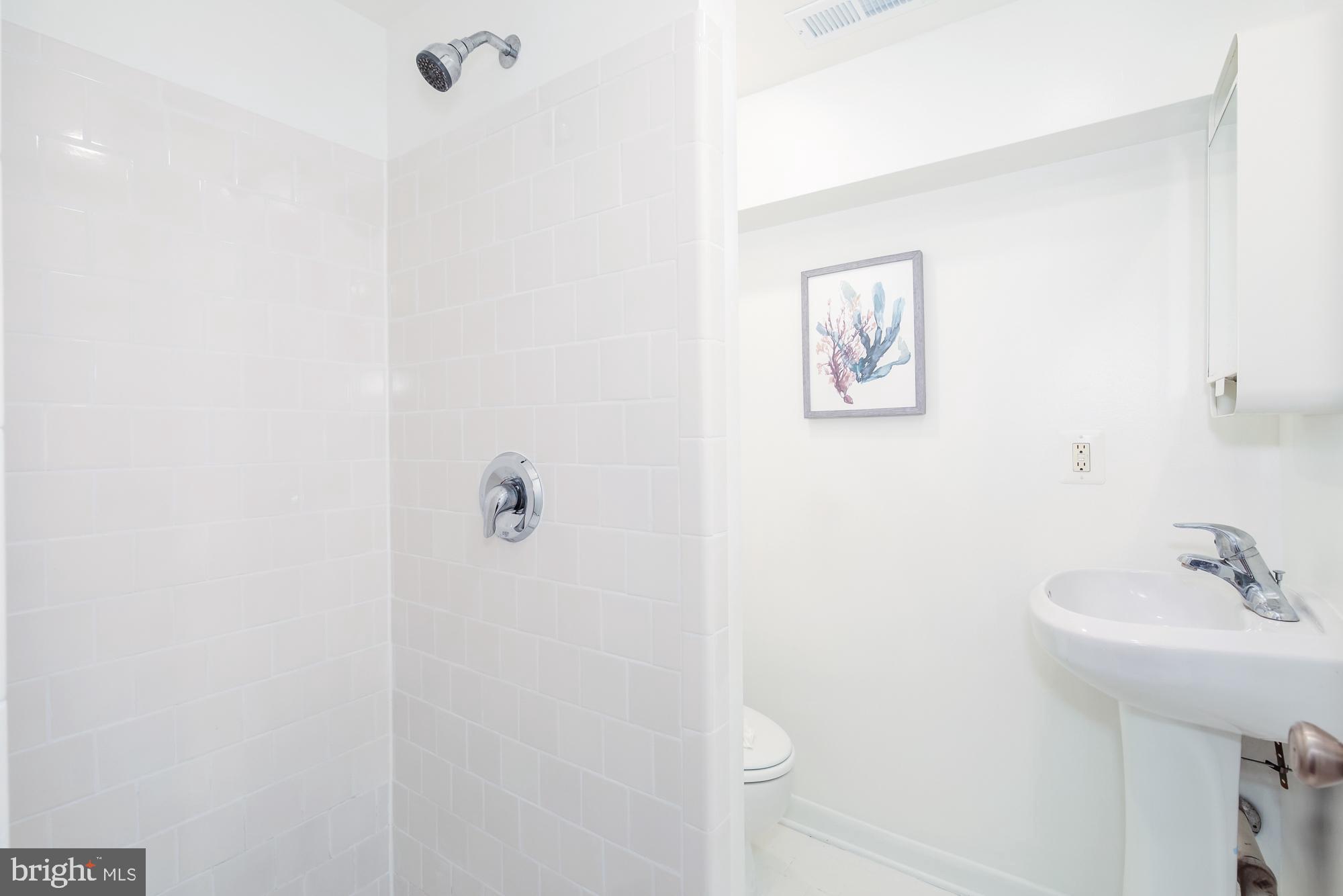 151 Thomas Street Northwest Washington, DC 20001 - Photo 32 of 40 a bathroom with a sink and mirror