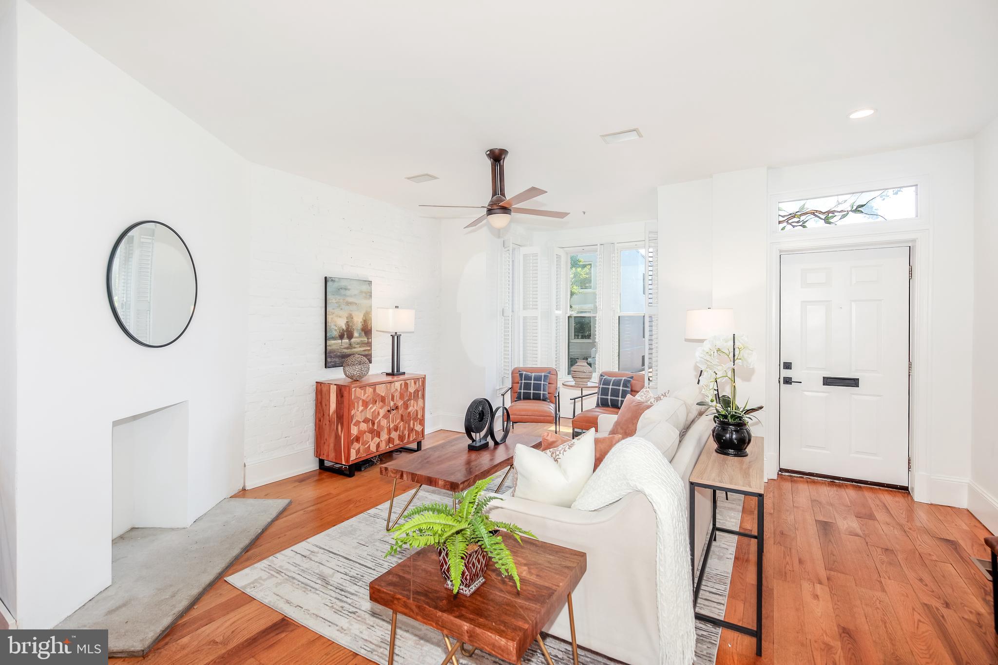 151 Thomas Street Northwest Washington, DC 20001 - Photo 4 of 40 a living room with furniture a fireplace and a chandelier