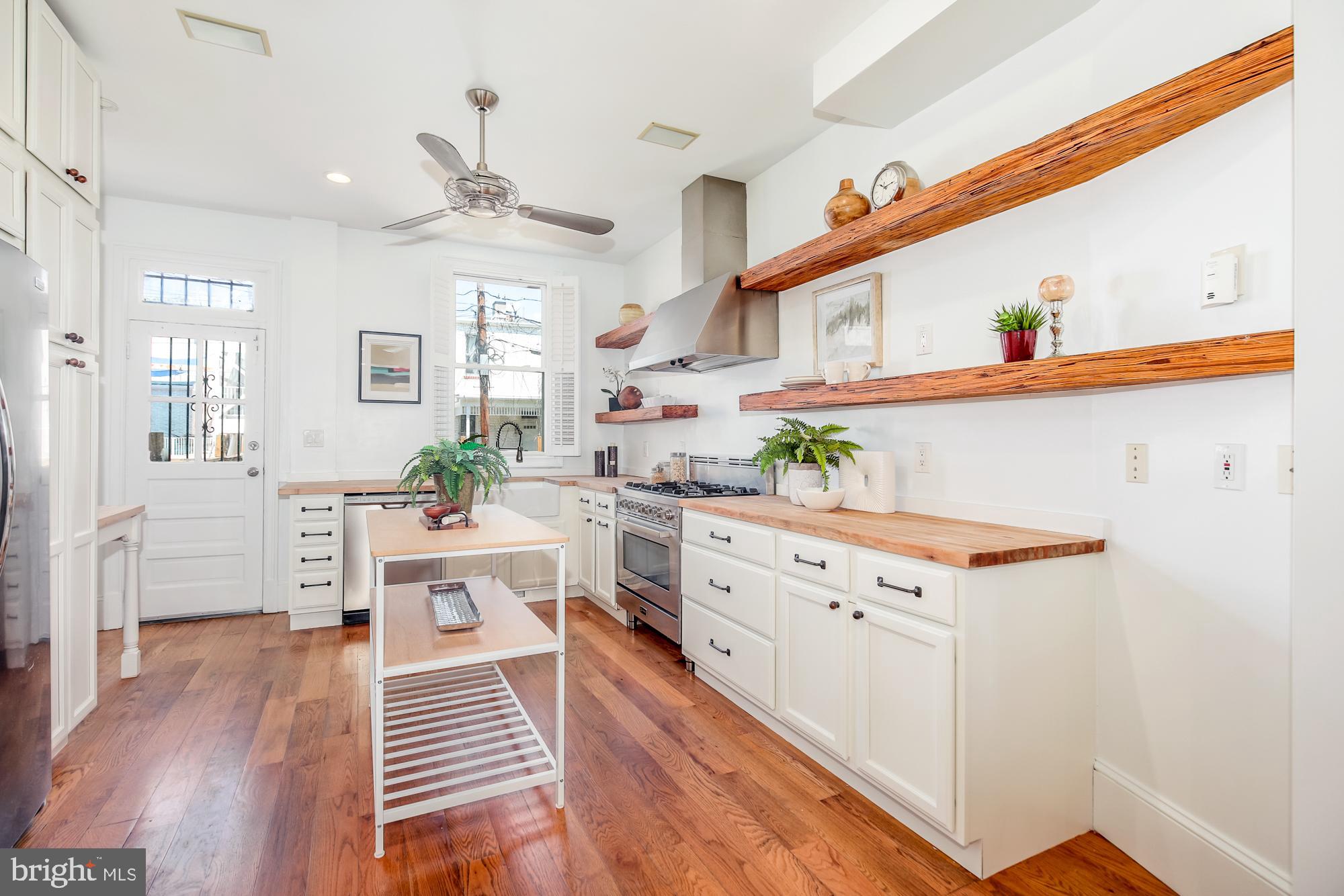 151 Thomas Street Northwest Washington, DC 20001 - Photo 9 of 40 a kitchen with stainless steel appliances a stove and more cabinets