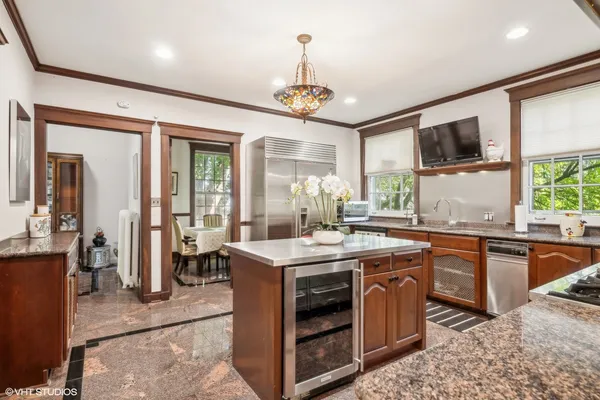 a kitchen with stainless steel appliances granite countertop a stove a sink and a refrigerator