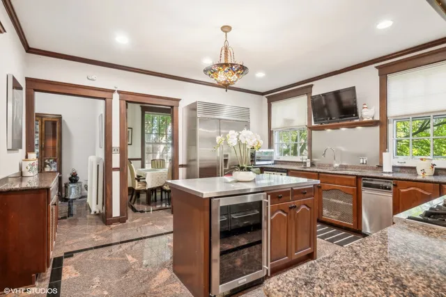 a kitchen with stainless steel appliances granite countertop a stove a sink and a refrigerator