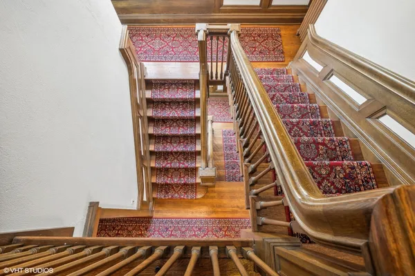 a view of staircase with wooden floor