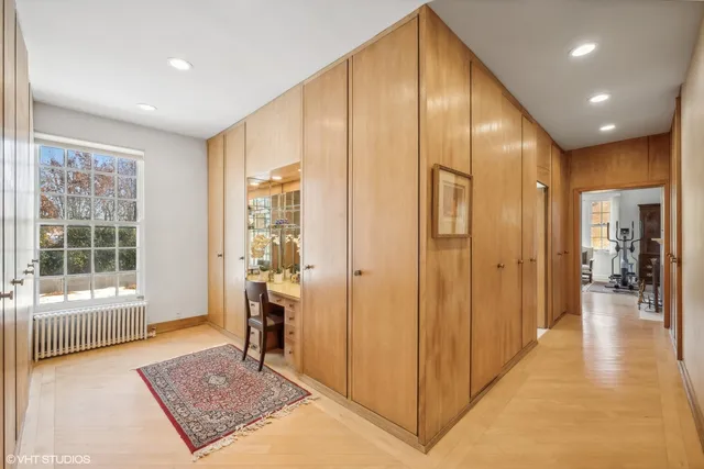 a view of hallway with a couch and windows