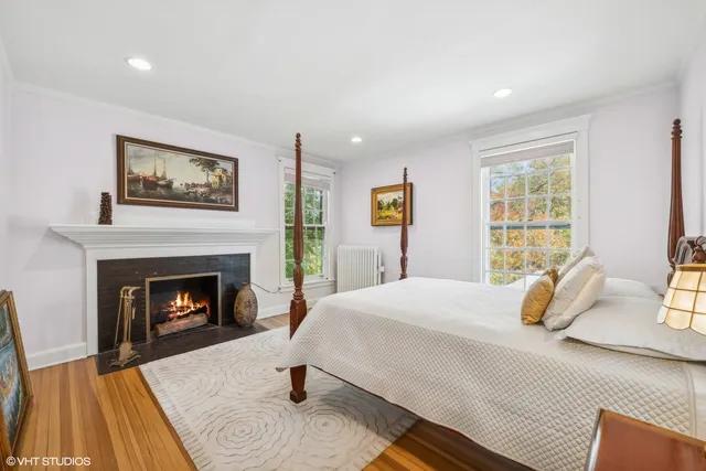 a bedroom with a bed and a fireplace