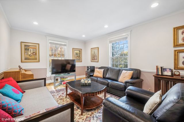 a living room with furniture a couch and a flat screen tv