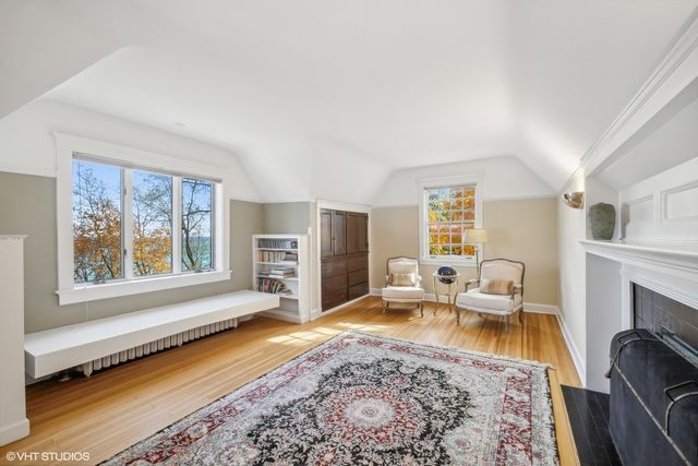 a living room with fireplace furniture and a rug