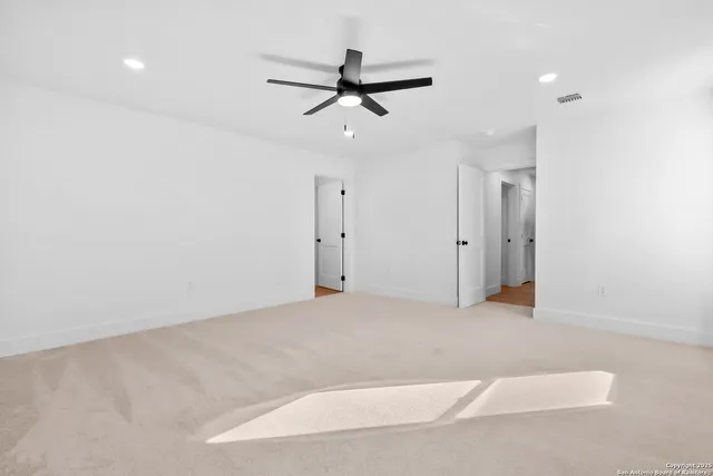 an empty room with closet and windows