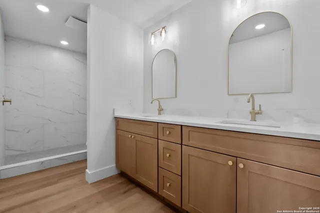 a bathroom with a double vanity sink and a mirror