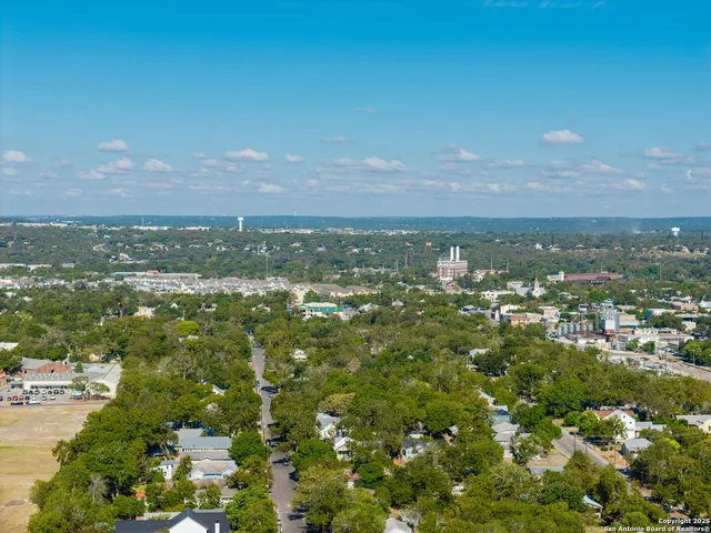 a view of a house with a tree in the background