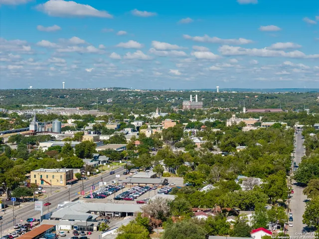 an aerial view of residential houses with city view