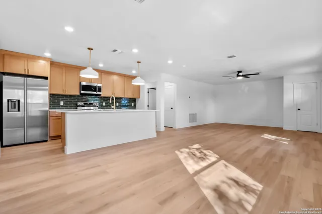 a view of a kitchen with a sink and an oven