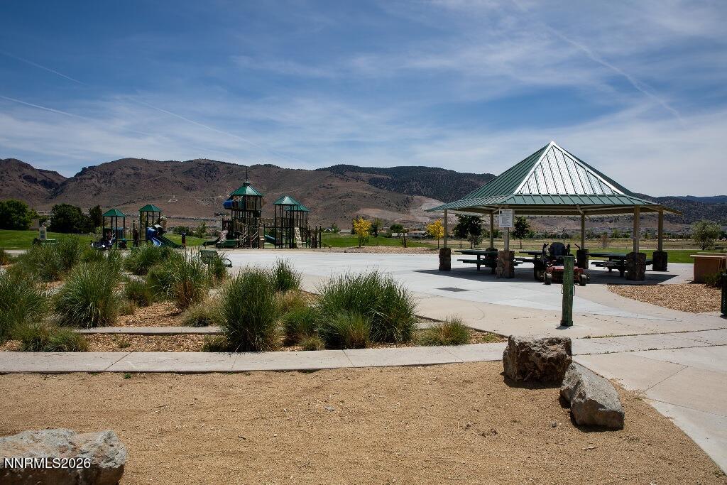 1864 Wind Ranch Road, Unit B Reno, NV 89521 - Photo 39 of 42 a front view of a house with a garden and lake view