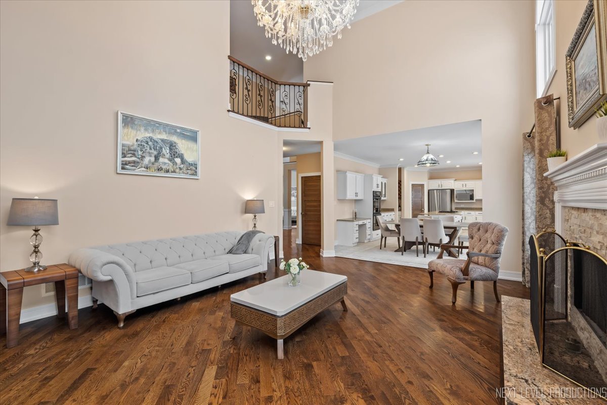 970 Waterside Court Aurora, IL 60502 - Photo 17 of 42 a living room with furniture and a chandelier