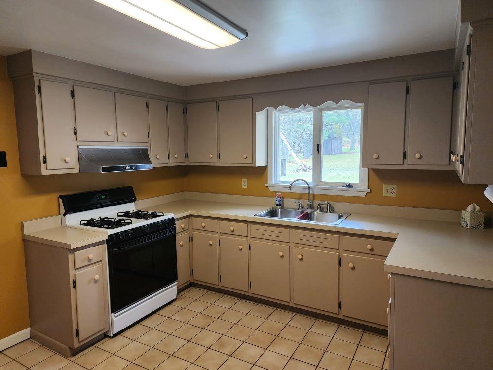 427 Lutz School Road Indiana, PA 15701 - Photo 3 of 15 a kitchen with a stove sink and cabinets
