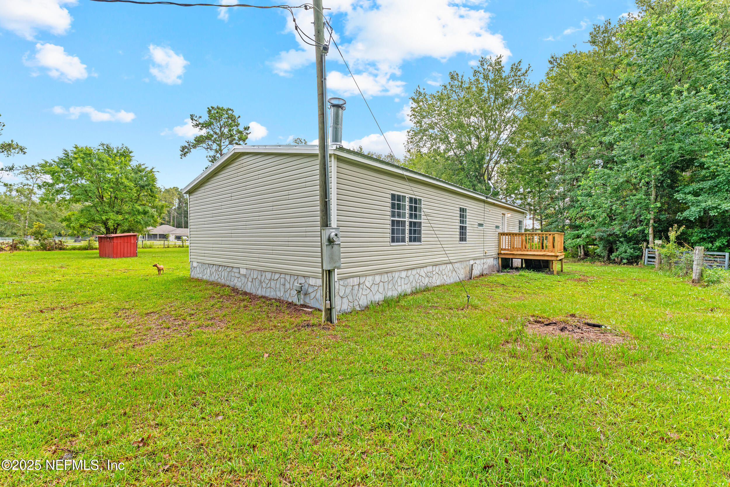 37341 Old Pineridge Road Hilliard, FL 32046 - Photo 23 of 27 a yellow house with garden in front of it