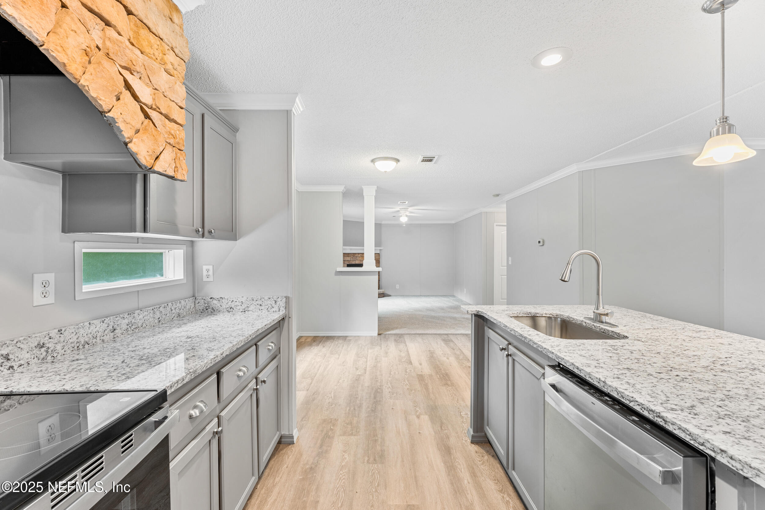 37341 Old Pineridge Road Hilliard, FL 32046 - Photo 9 of 27 a kitchen with granite countertop a sink stove and cabinets