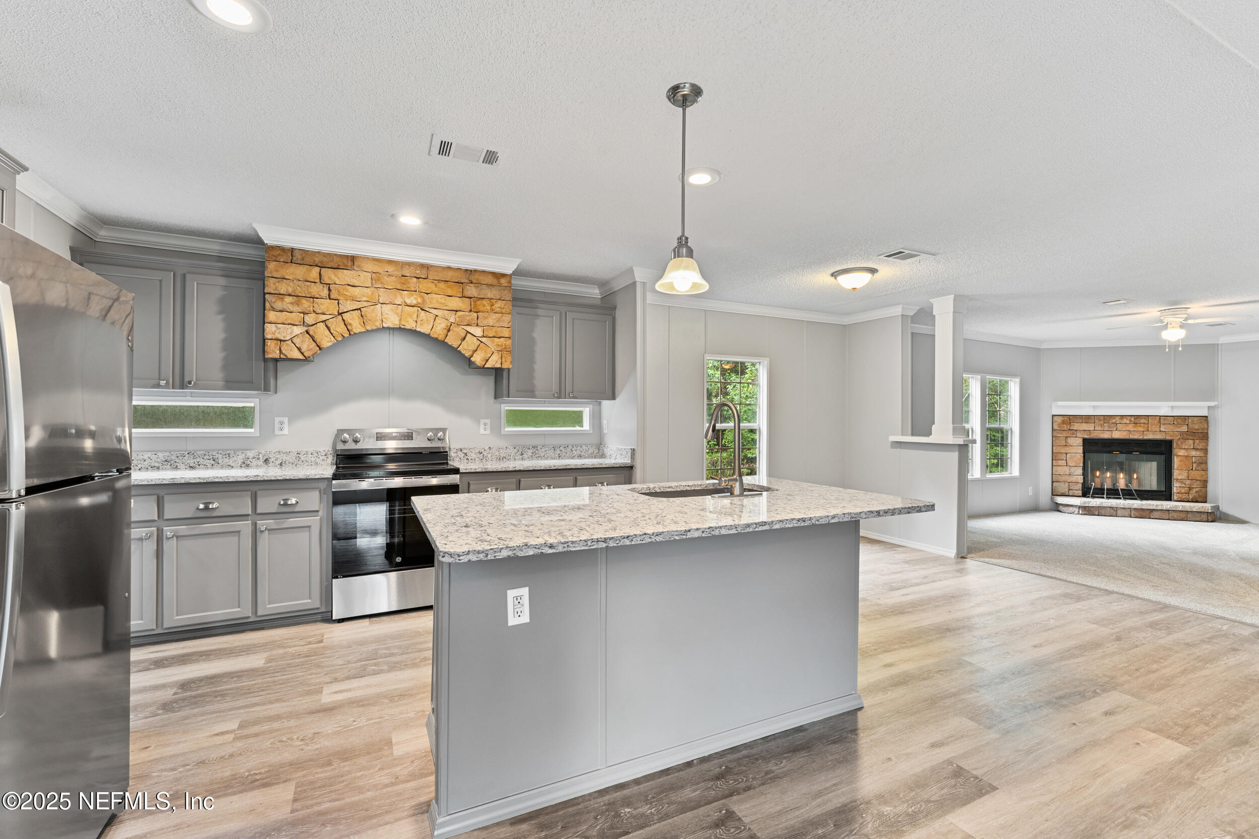 37341 Old Pineridge Road Hilliard, FL 32046 - Photo 10 of 27 a kitchen with stainless steel appliances granite countertop a stove and a sink