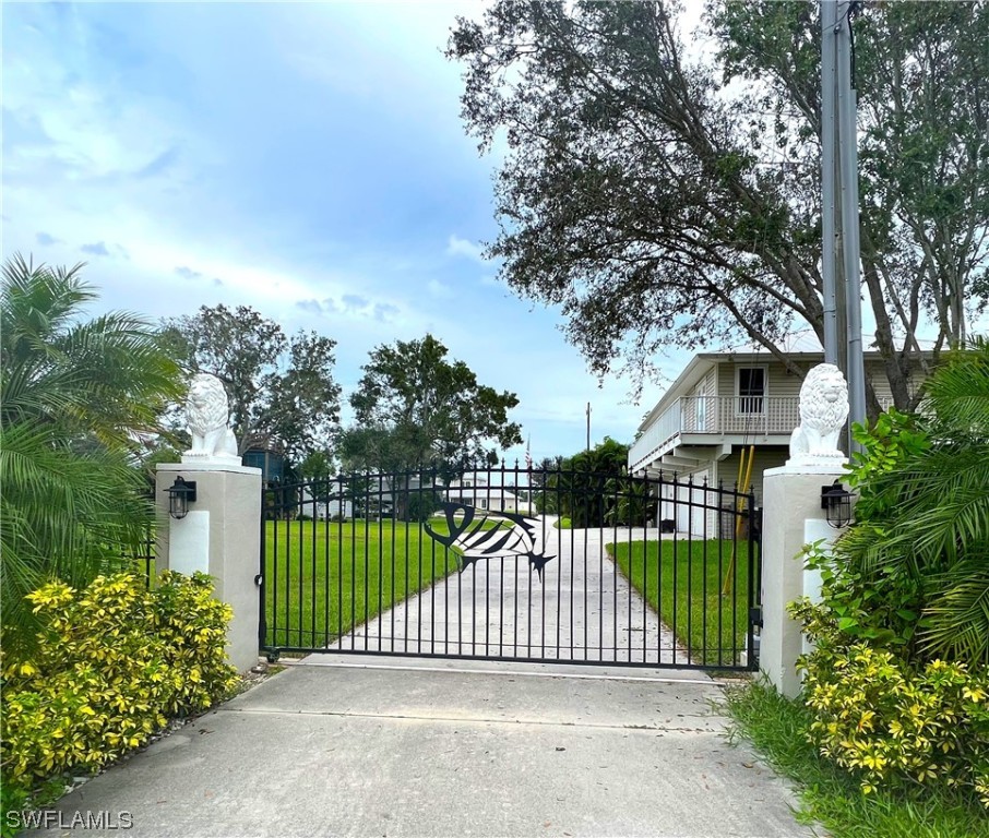 12614 River Road Fort Myers, FL 33905 - Photo 2 of 50 a view of a house with a small yard and plants