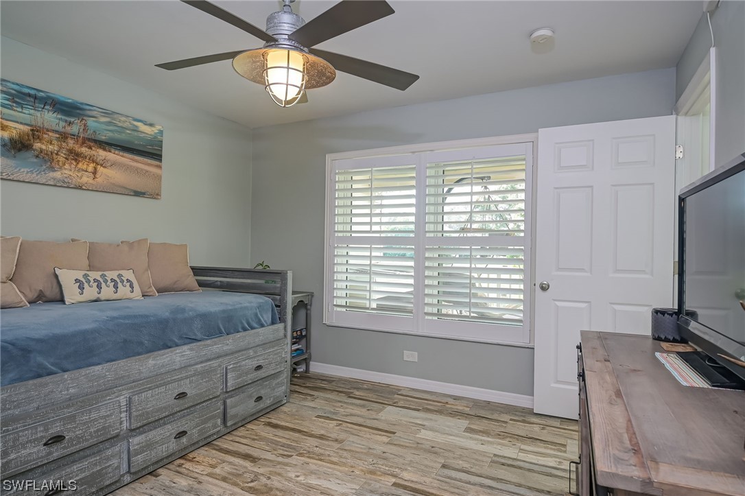 12614 River Road Fort Myers, FL 33905 - Photo 22 of 50 a spacious bedroom with a bed and a chandelier
