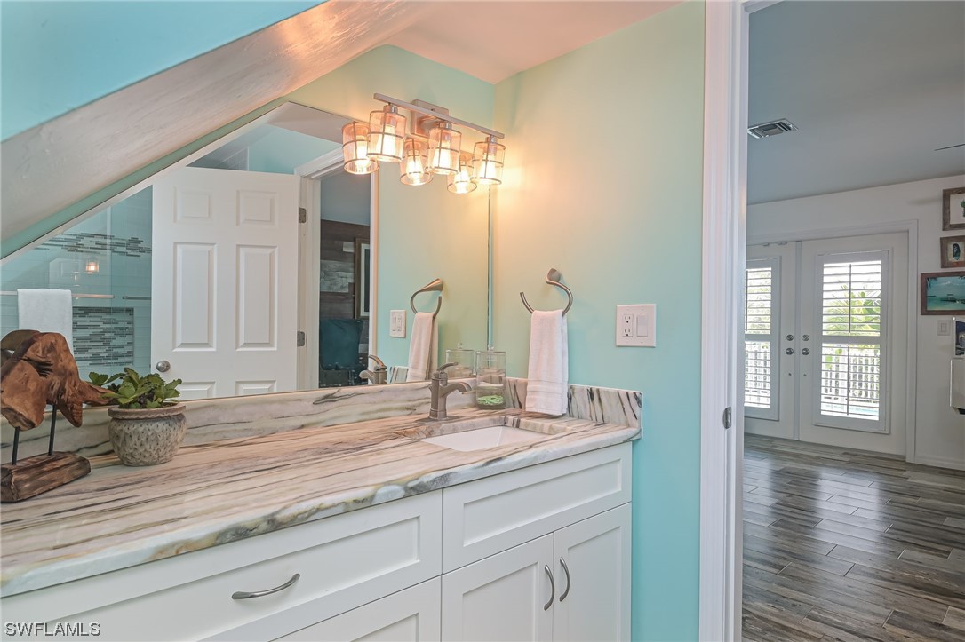 12614 River Road Fort Myers, FL 33905 - Photo 23 of 50 a bathroom with a double vanity sink and a mirror