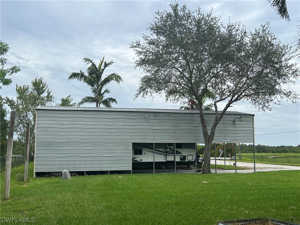 12614 River Road Fort Myers, FL 33905 - Photo 40 of 50 a front view of a house with a garden and plants