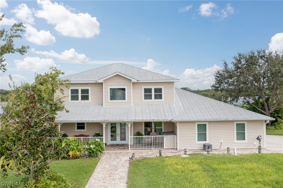 12614 River Road Fort Myers, FL 33905 - Photo 4 of 50 a front view of house with yard and green space