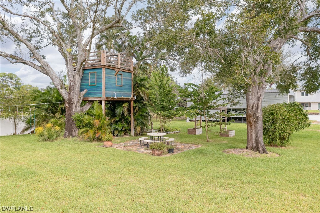 12614 River Road Fort Myers, FL 33905 - Photo 41 of 50 a backyard of a house with yard and outdoor seating